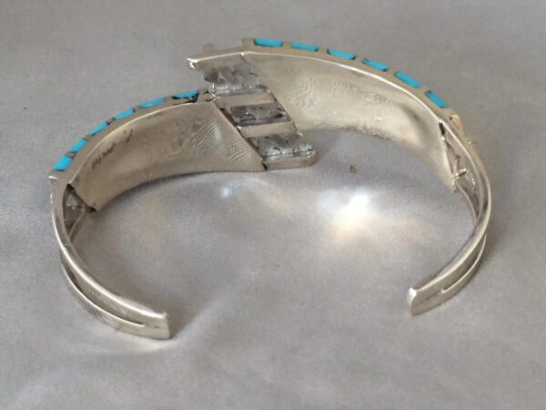 A Silver Color Bracelet With Blue Stones Inside