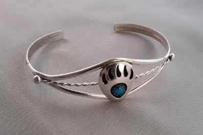 A Silver Color Bracelet With Blue Stone