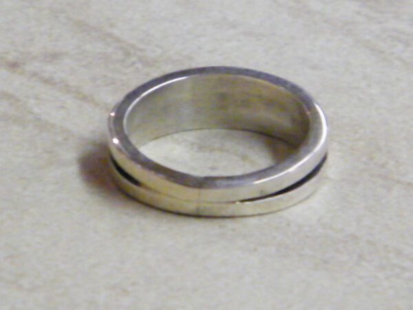Mens wedding band, white opal muskett placed on the floor