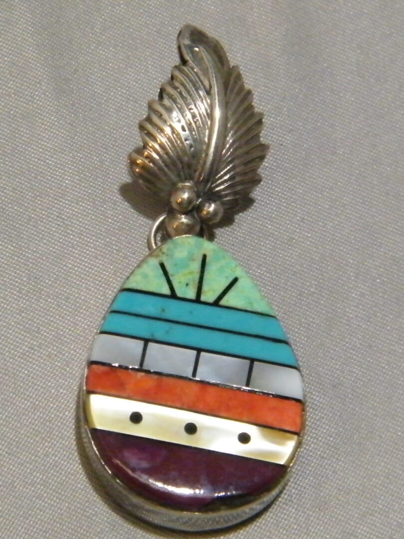 A Teal, Blue, White and Orange Drop Shaped Pendant