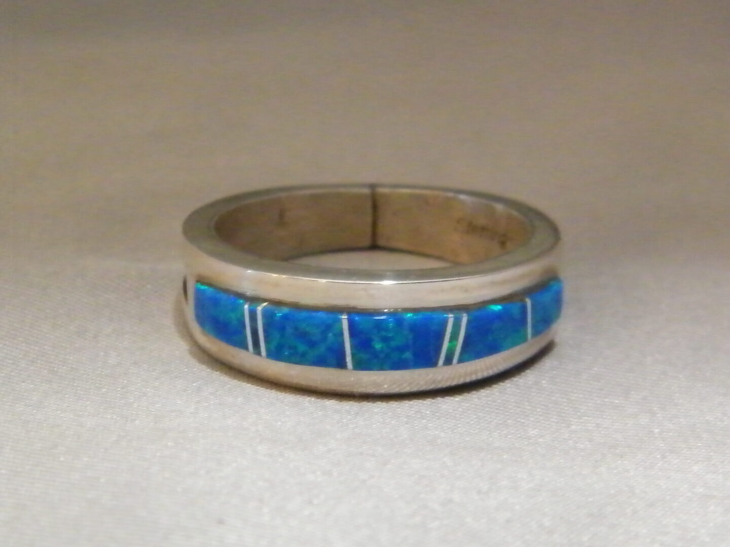 A Silver Ring With Blue Stone and White Lines