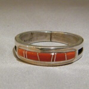 A Silver Ring With Orange Stone and Gold Lines