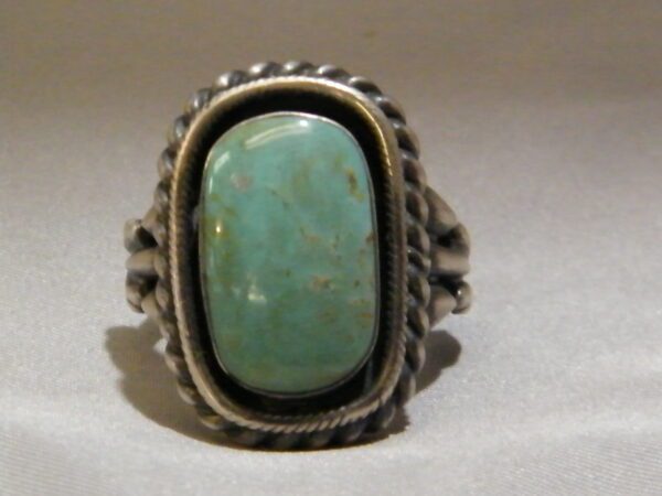 A Silver Color Ring With Oval Teal Color Stone One