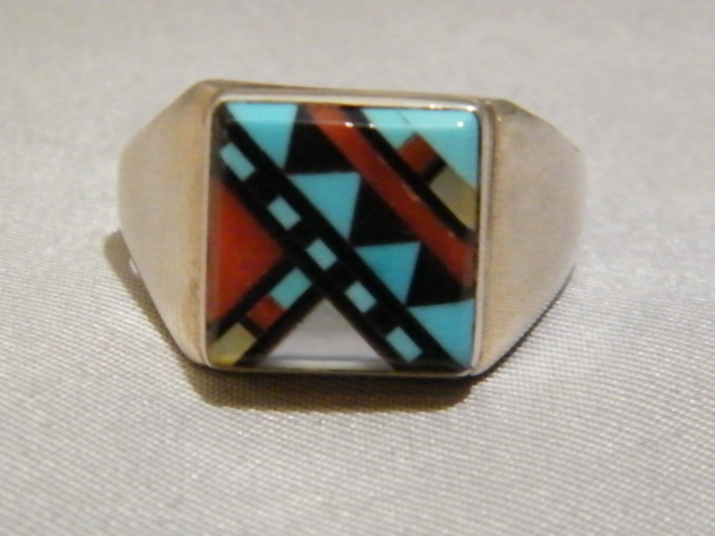 A Silver Ring With Blue, Black and White Square Stone