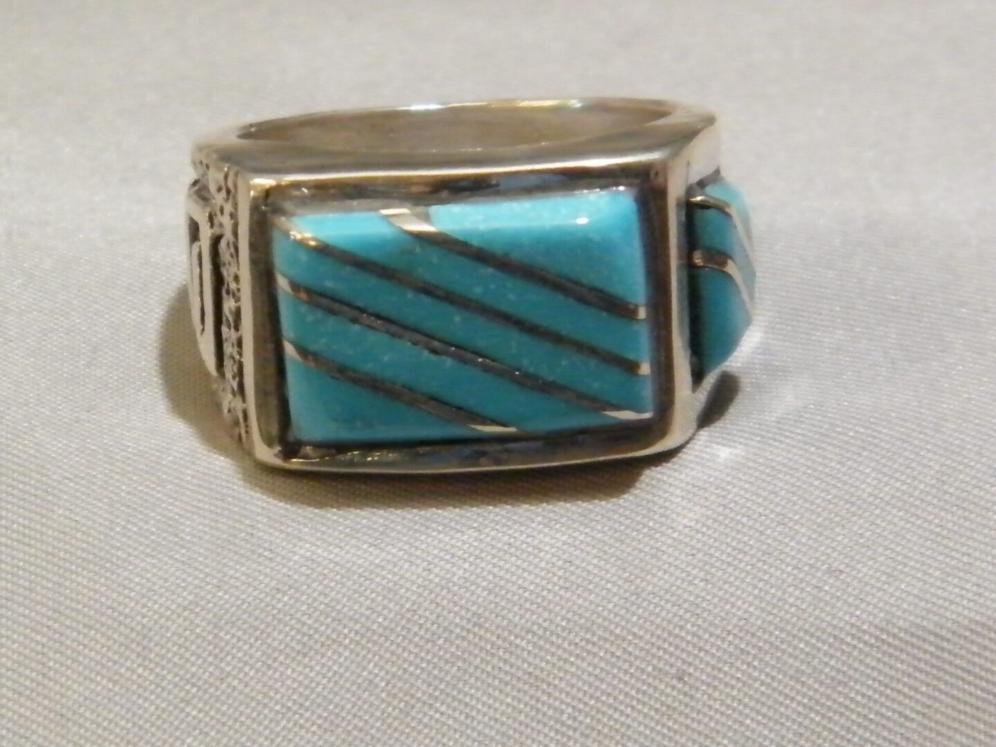 A Silver Color Ring With Blue and Silver Color Stone One