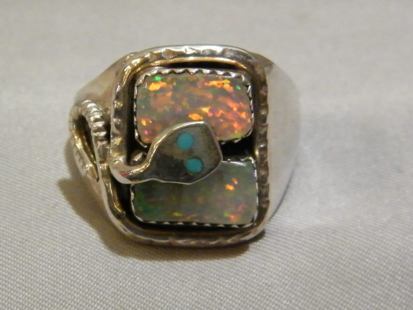 A Gold Ring With Gold Stone and Snake Pattern